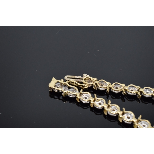 415 - 9ct gold and white gold tennis bracelet with illusion set diamonds. 6.3 grams. 19cm long.