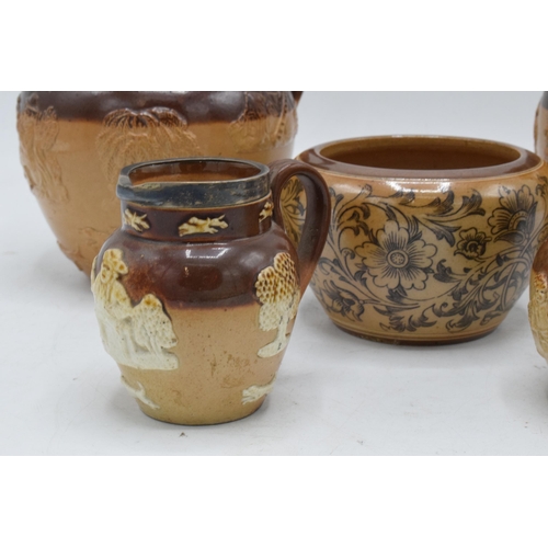 35 - A collection of Royal Doulton and Doulton Lambeth stoneware to include two-tone jugs, a floral vase ... 