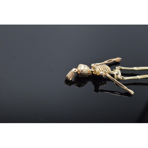 417 - 9ct gold pendant in the form of an anatomical skeleton. 2.4 grams. 4.5cm tall.