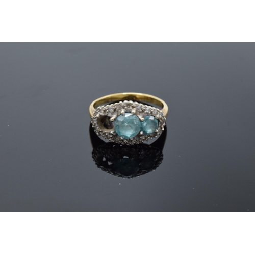 442 - An 18ct gold ring with illusion set diamonds and aqua marines (4.7 grams gross weight) (or similar) ... 