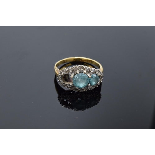 442 - An 18ct gold ring with illusion set diamonds and aqua marines (4.7 grams gross weight) (or similar) ... 