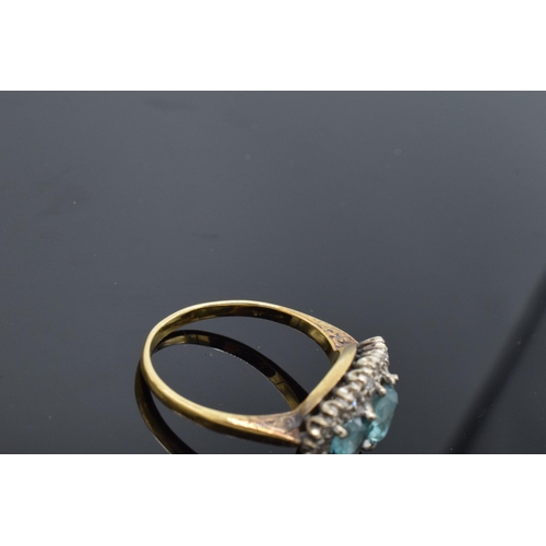 442 - An 18ct gold ring with illusion set diamonds and aqua marines (4.7 grams gross weight) (or similar) ... 