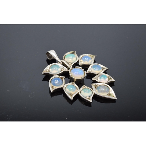 456 - A silver and opal leaf-shaped pendant.