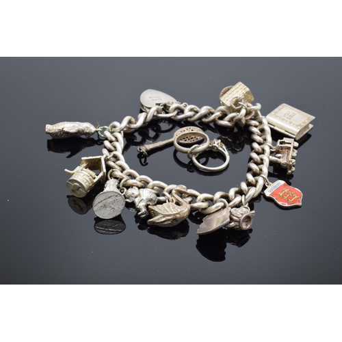 458 - A silver charm bracelet with a few extra charms. 63.3 grams.