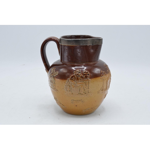 45A - Doulton Lambeth two-tone stoneware jug with traditional scenes with silver rim. H 14cm. In good cond... 