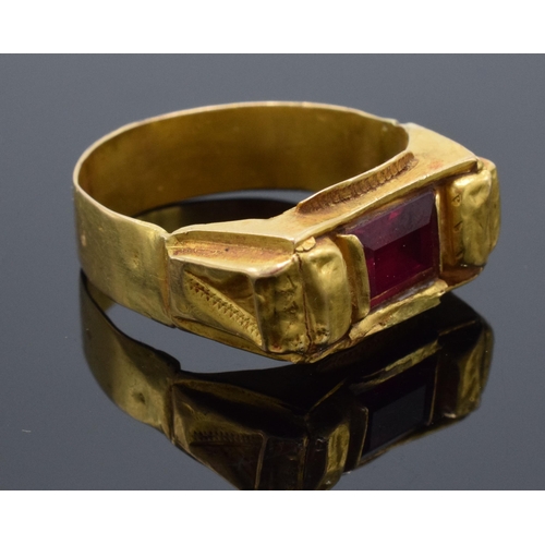 460 - High carat gold ring (22ct +) set with a red stone. 4.7 grams gross weight. UK size V/W.