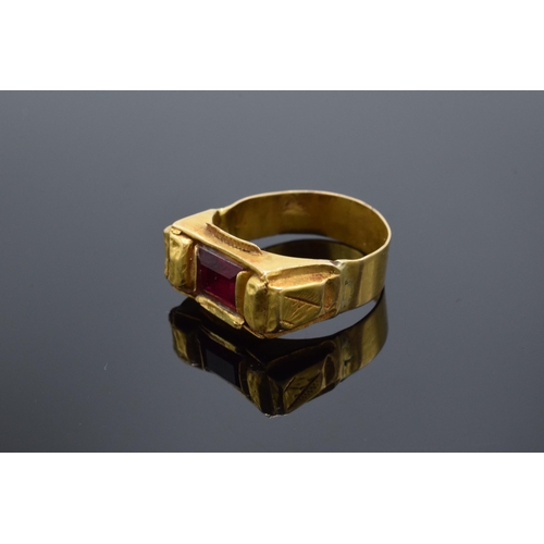 460 - High carat gold ring (22ct +) set with a red stone. 4.7 grams gross weight. UK size V/W.