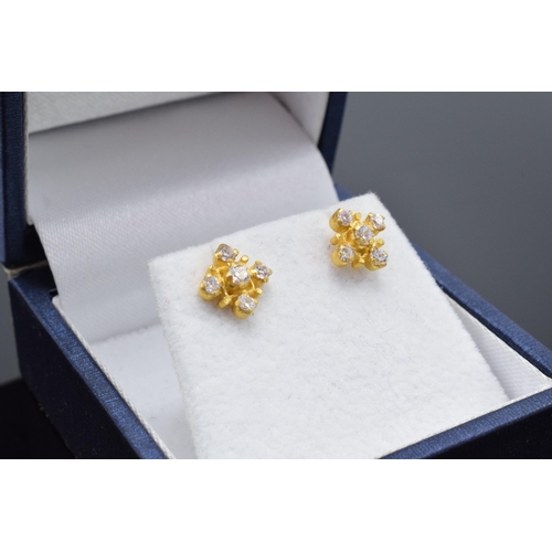 467 - A pair of 22ct gold and CZ stone earrings. 1.9 grams.