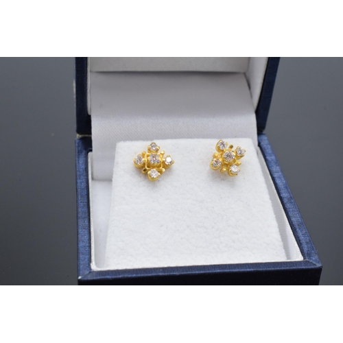 467 - A pair of 22ct gold and CZ stone earrings. 1.9 grams.