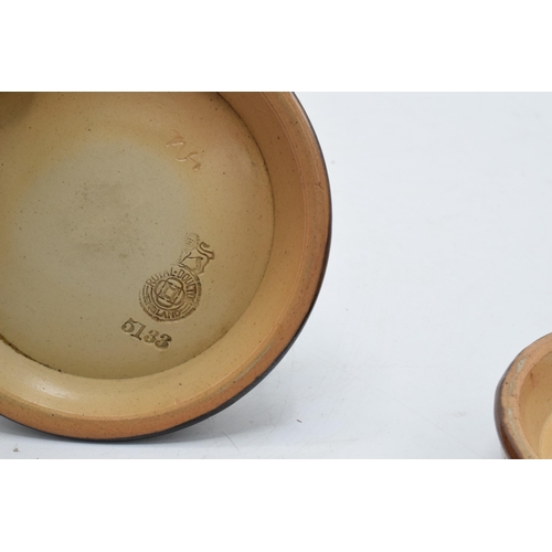 48 - A pair of Royal Doulton stoneware advertising ash trays to include Whitbread's Ale and Stout togethe... 