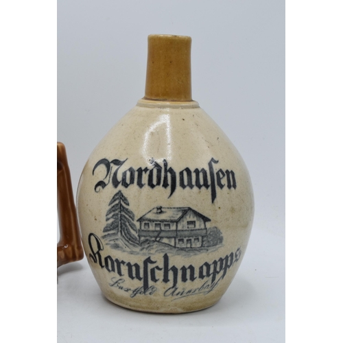 50 - A pair of stoneware flagons to include a Nordhausen Kornschnapps example and a Nordhauser Kornbranti... 