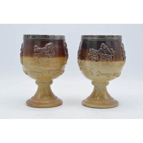 52 - A pair of 19th century stoneware goblets depicting traditional hunting and country scenes with both ... 