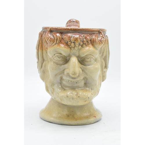 53 - A 19th century stoneware character jug in the form of Bacchus. 19cm tall. Generally in good conditio... 