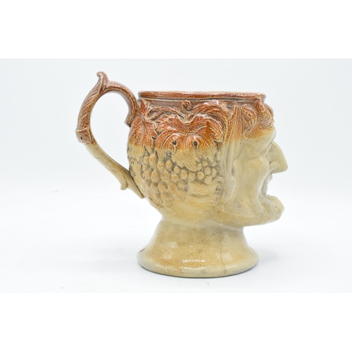 53 - A 19th century stoneware character jug in the form of Bacchus. 19cm tall. Generally in good conditio... 