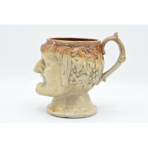 53 - A 19th century stoneware character jug in the form of Bacchus. 19cm tall. Generally in good conditio... 