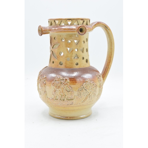 55 - A 19th century Nottingham brown stoneware puzzle jug of traditional form with pierced decoration wit... 