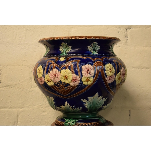 57 - A 19th century majolica jardinière bowl and stand with foliage on a blue background in an Art-Nouvea... 