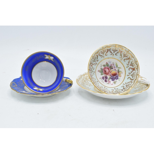 73 - A Paragon Fine Bone China cup and saucer in a regal pattern with still life of fruit design together... 