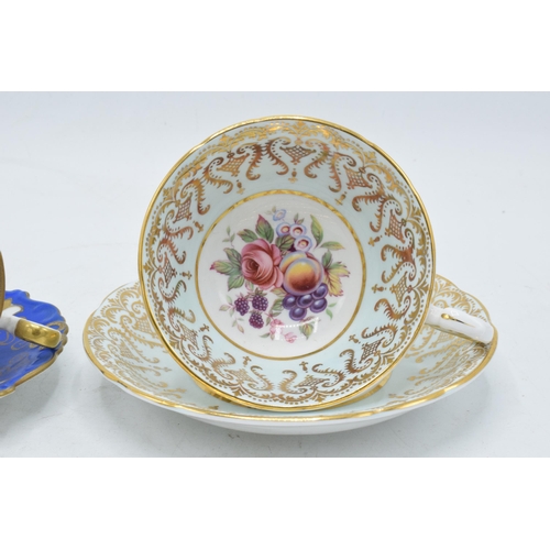 73 - A Paragon Fine Bone China cup and saucer in a regal pattern with still life of fruit design together... 