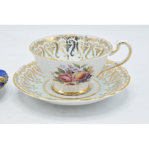 73 - A Paragon Fine Bone China cup and saucer in a regal pattern with still life of fruit design together... 