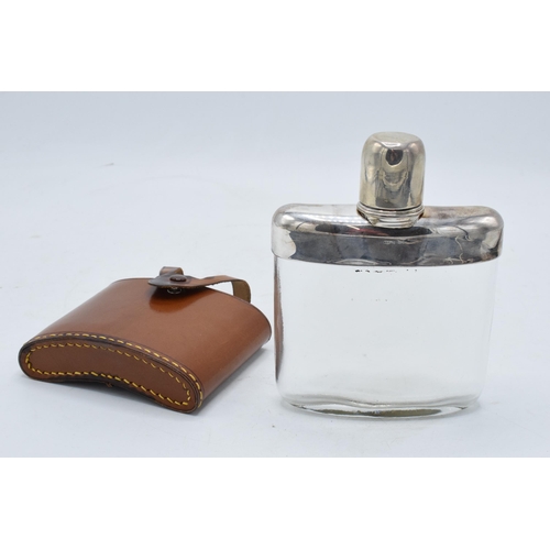 225M - Scandinavian silver and glass hipflask with a leather cover. 14cm tall.