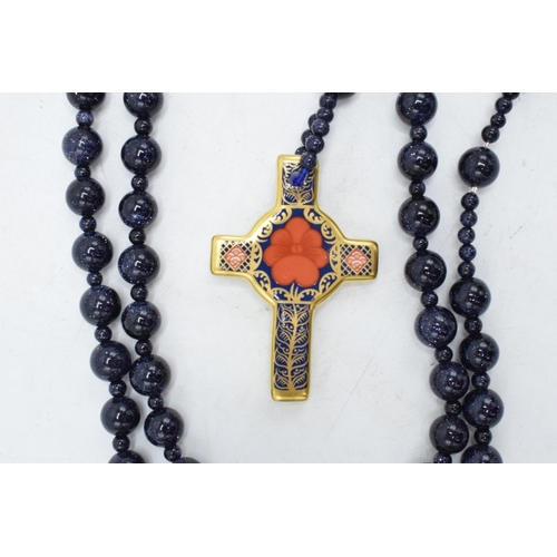 100W - Royal Crown Derby Imari Rosary Cross pendant set on a blue beaded necklace, complete with box. As ne... 