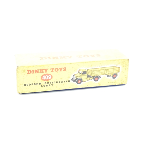 333 - Boxed Dinky Toys No.409 yellow / orange Bedford Articulated Lorry. GC to VGC condition with some pai... 