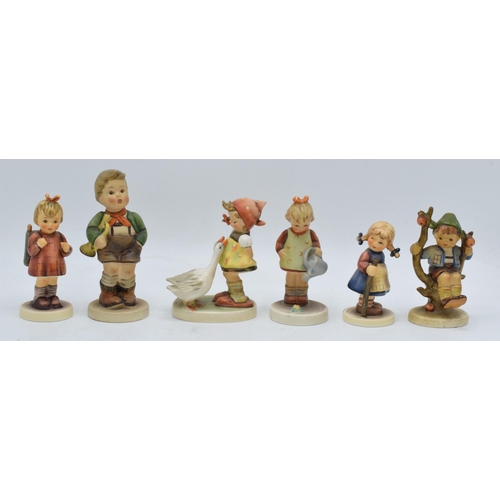 61 - A collection of Goebel / Hummel figures to include What's That?, boy in apple tree, boy with trumpet... 