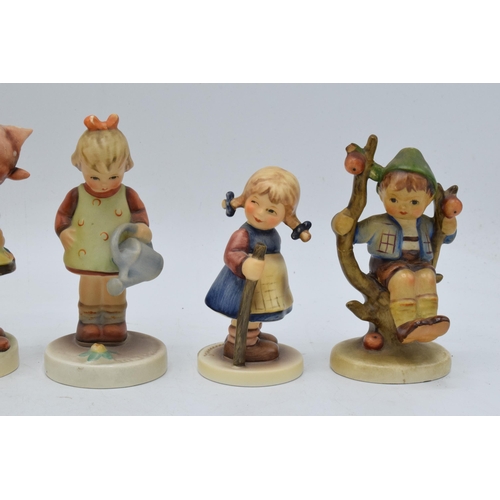 61 - A collection of Goebel / Hummel figures to include What's That?, boy in apple tree, boy with trumpet... 