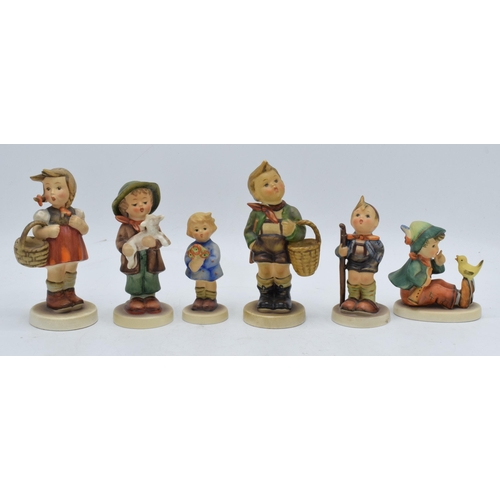 62 - A collection of Goebel / Hummel figures to include Girl with Flowers, boy with chick, girl with bask... 