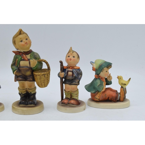 62 - A collection of Goebel / Hummel figures to include Girl with Flowers, boy with chick, girl with bask... 