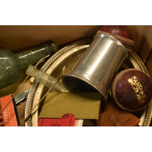 23 - A mixed collection of items to include vintage cricket balls, Picture Puzzles, glass bottles, tin pl... 