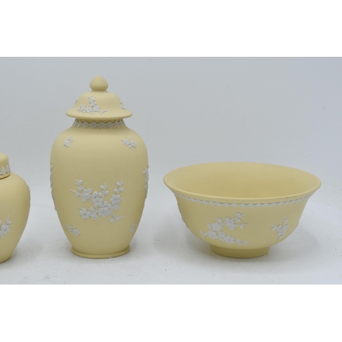 74 - A collection of Wedgwood yellow Jasperware to include a 15cm diameter bowl, 2 lidded pots and a tall... 