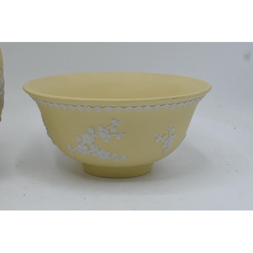 74 - A collection of Wedgwood yellow Jasperware to include a 15cm diameter bowl, 2 lidded pots and a tall... 