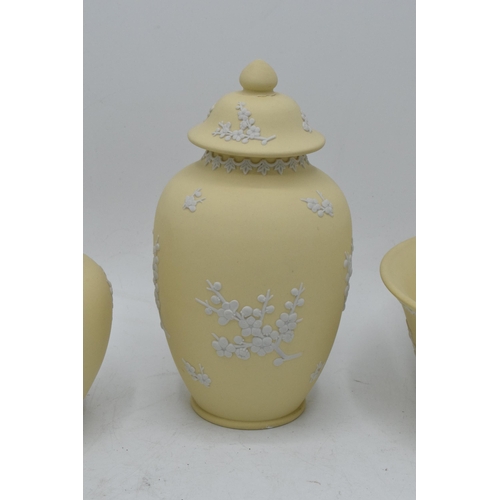 74 - A collection of Wedgwood yellow Jasperware to include a 15cm diameter bowl, 2 lidded pots and a tall... 