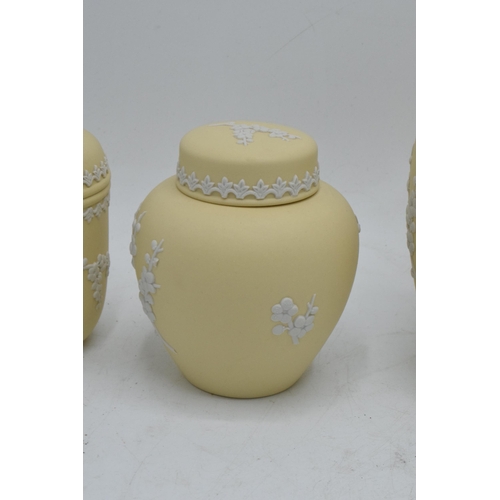 74 - A collection of Wedgwood yellow Jasperware to include a 15cm diameter bowl, 2 lidded pots and a tall... 