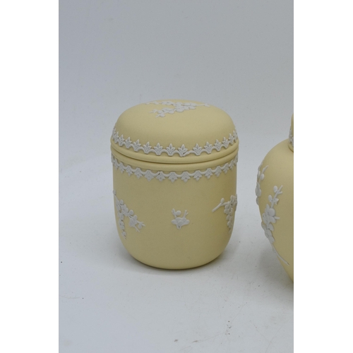 74 - A collection of Wedgwood yellow Jasperware to include a 15cm diameter bowl, 2 lidded pots and a tall... 