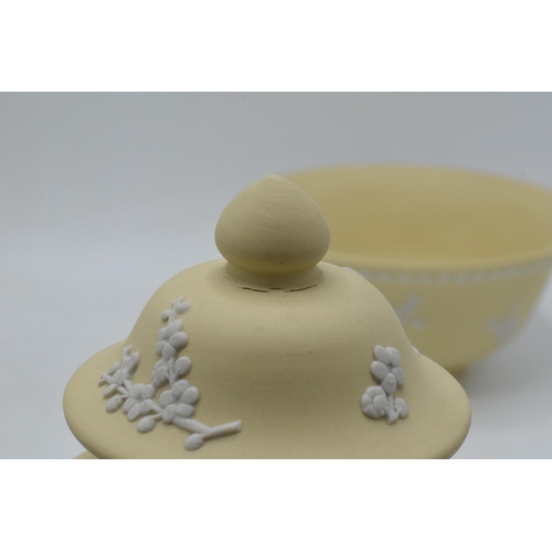 74 - A collection of Wedgwood yellow Jasperware to include a 15cm diameter bowl, 2 lidded pots and a tall... 