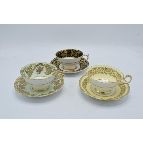 79 - A trio of Paragon Fine Bone China cups and saucers decorated with majestic floral scenes (6 pieces).... 