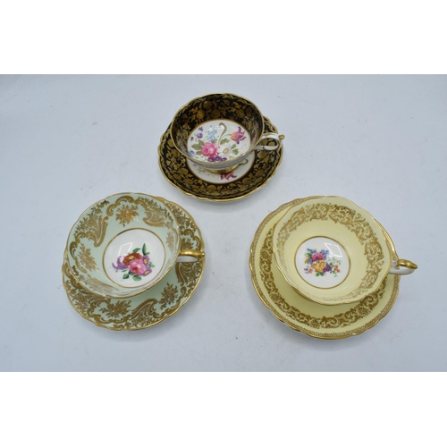 79 - A trio of Paragon Fine Bone China cups and saucers decorated with majestic floral scenes (6 pieces).... 