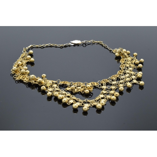 221K - A gilt metal decorative necklace. 45cm long.