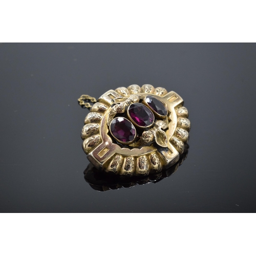 221L - Victorian gold brooch set with 3 large garnets and safety chain. Gross weight 5.6 grams.