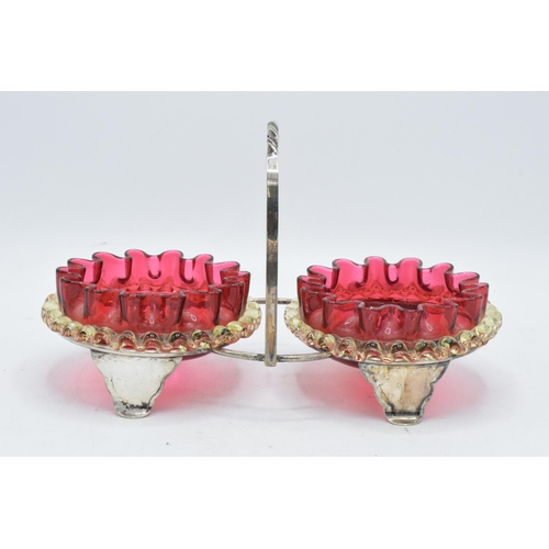 46 - A pair of early 20th century cranberry and vaseline glass preserve dishes with a silver plated frame... 