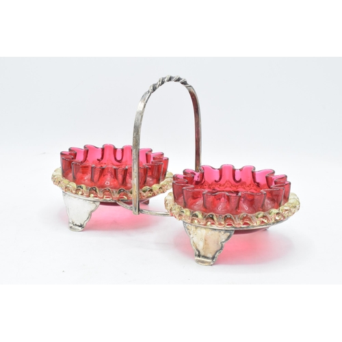 46 - A pair of early 20th century cranberry and vaseline glass preserve dishes with a silver plated frame... 