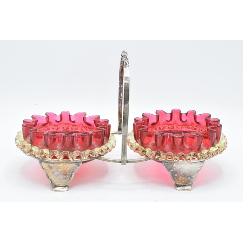 46 - A pair of early 20th century cranberry and vaseline glass preserve dishes with a silver plated frame... 