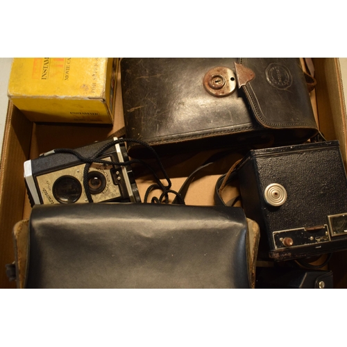 358 - A collection of cameras and camera equipment to include a Houghton camera, various Kodak Brownies, C... 