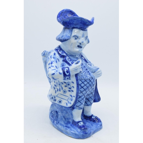 36 - A large French pottery Toby jug decorated in a blue glaze in a Faience or Delft style with markings ... 