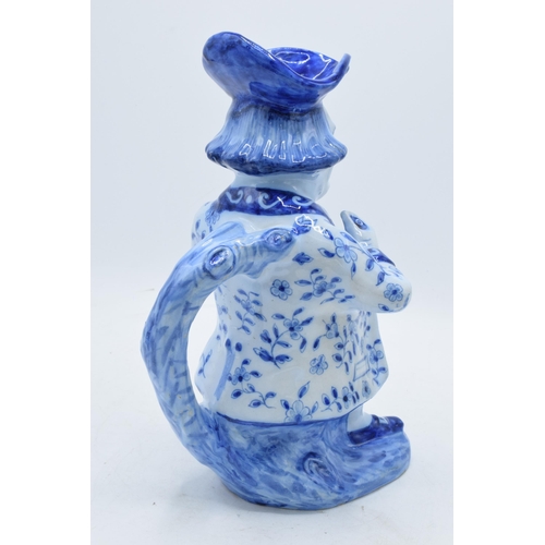 36 - A large French pottery Toby jug decorated in a blue glaze in a Faience or Delft style with markings ... 