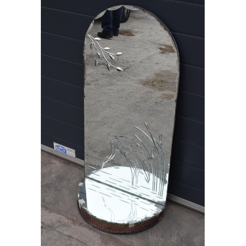 363 - A large domed mirror with mirrored shelf with decoration to main panel. 98cm tall.