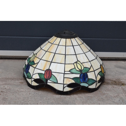 364 - A large Tiffany - style domed lampshade with floral decoration. 45cm diameter.